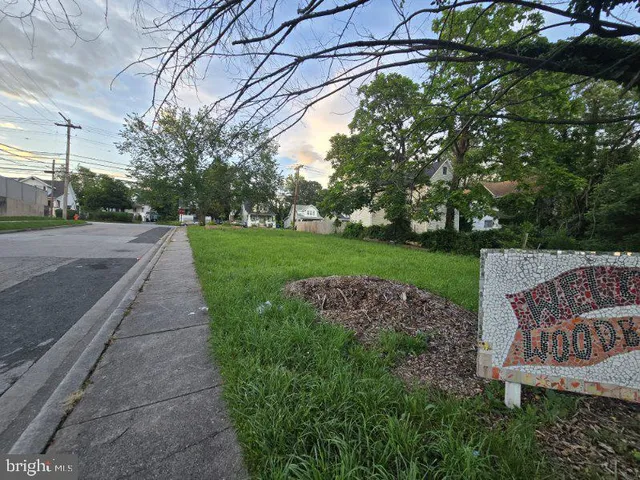 a view of a street with a bench in the background