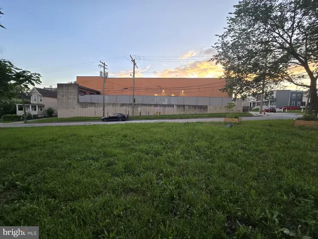 a view of a large building with a big yard and large trees