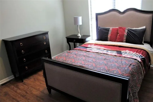 a bed sitting in a bedroom with a dresser