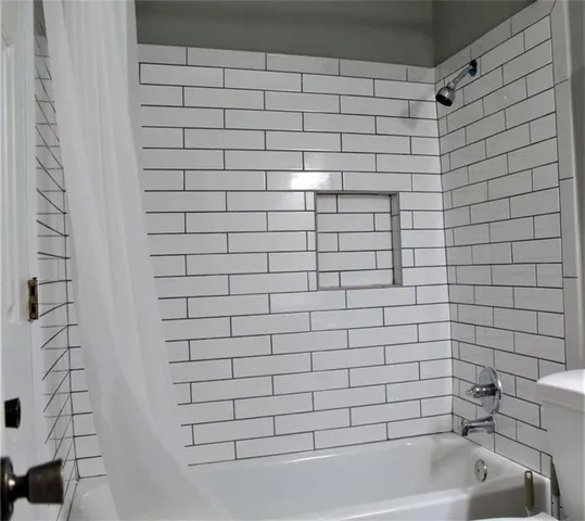 a bathroom with a bathtub and shower