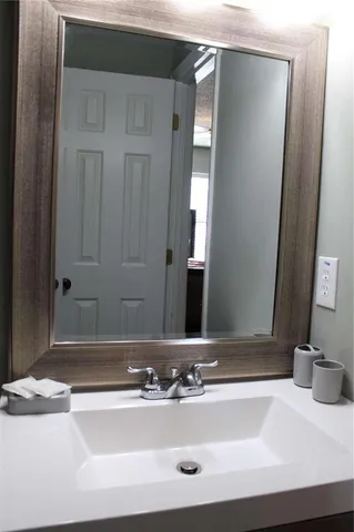 a bathroom with a sink and a mirror