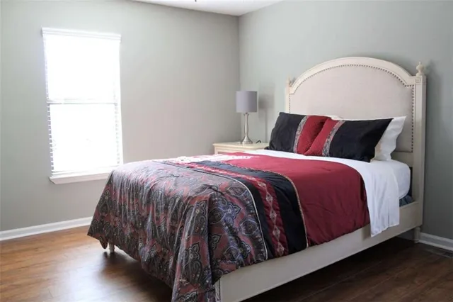 a bed sitting in a bedroom next to a window