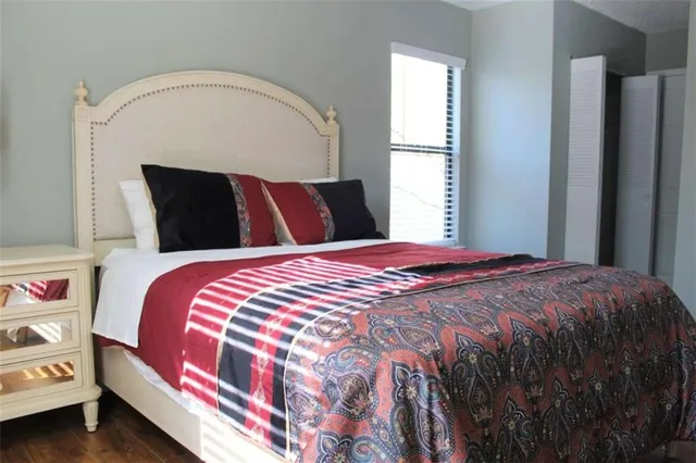 a bedroom with a bed and a window