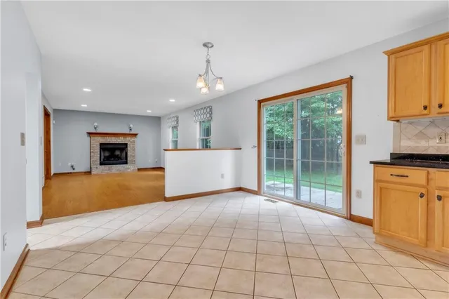 a view of an empty room with a fireplace and a window