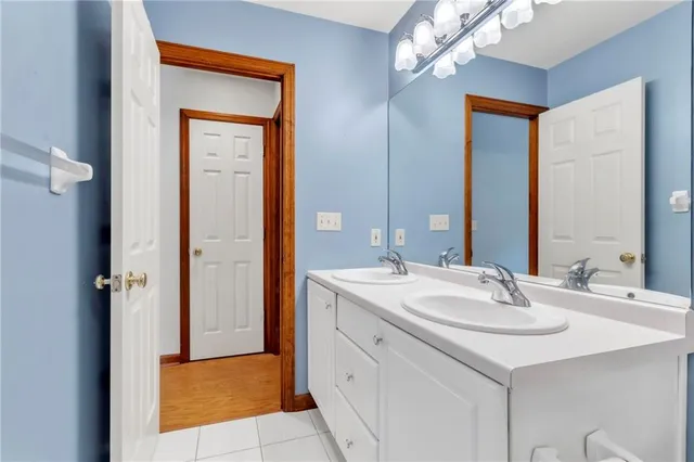 a bathroom with a sink vanity and a mirror