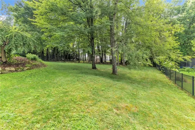 a view of a green field with trees