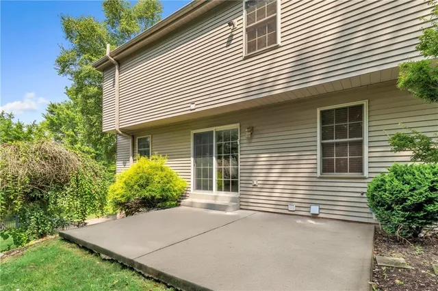 a view of a house with a yard and potted plants