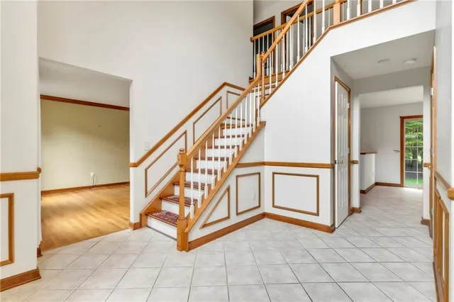 a view of an entryway with wooden floor and a livingroom view