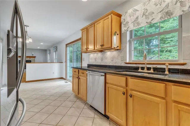a kitchen with stainless steel appliances granite countertop a refrigerator and a sink