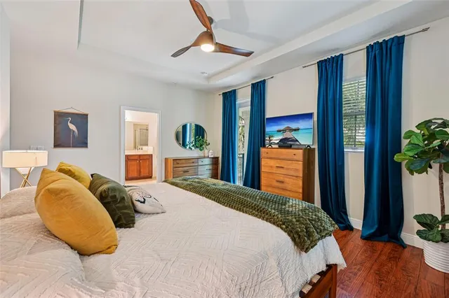 a bedroom with a bed and a wooden floor