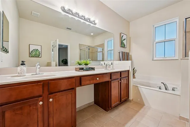 a bathroom with a sink a mirror and a bathtub