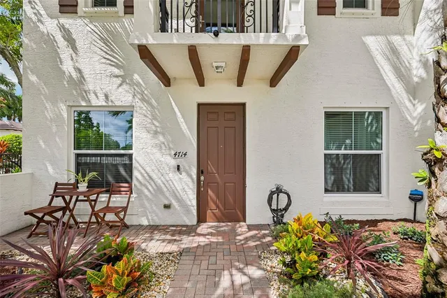 a front view of a house with outdoor seating
