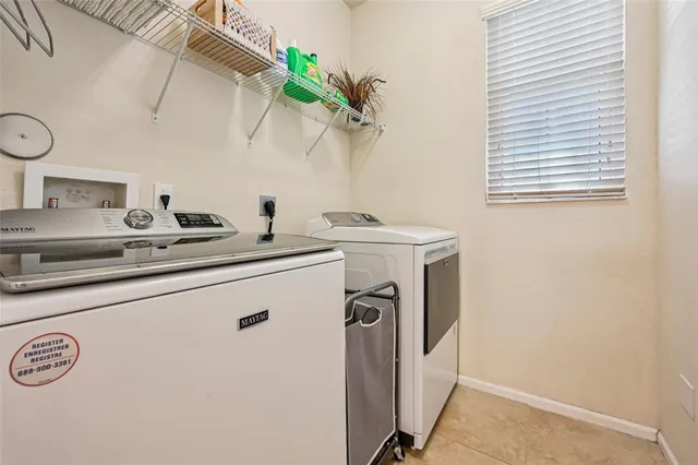 a view of a house with a yard and palm trees