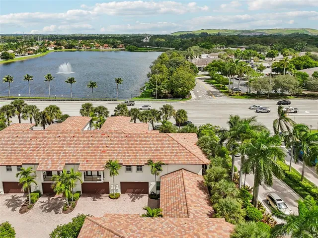 an aerial view of a house with yard and mountain view in back