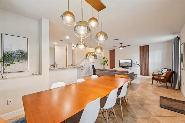a large kitchen with a table and chairs