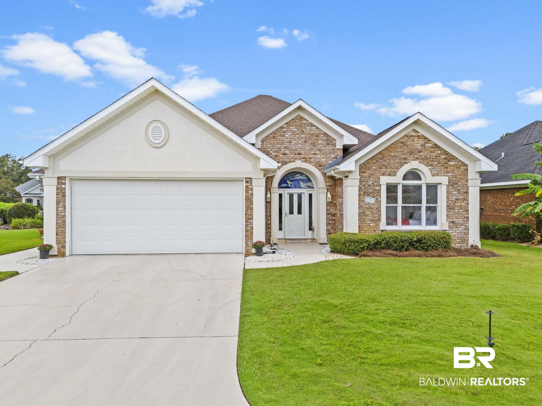 22512 Inverness Way Foley, AL 36535 - Photo 42 of 43 View of front facade featuring a front yard and a garage