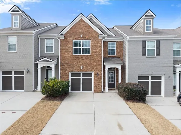a front view of a house with a garden