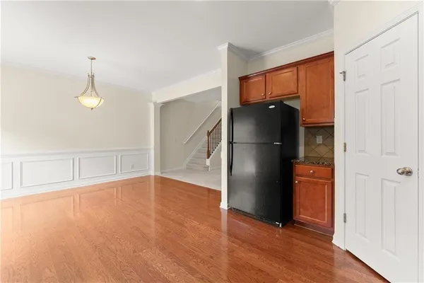 a view of empty room with wooden floor and cabinet
