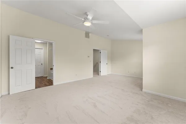 a view of an empty room with a ceiling fan