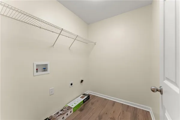 a view of a room with wooden floor