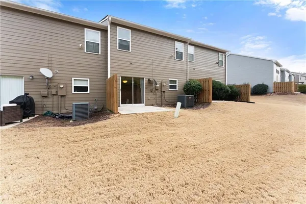 a view of a house with chairs in the patio