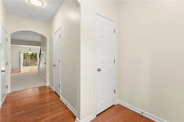 a view of a hallway with wooden floor