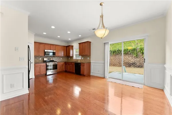 a view of kitchen with kitchen island granite countertop stainless steel appliances granite countertop counter space and a view of living room