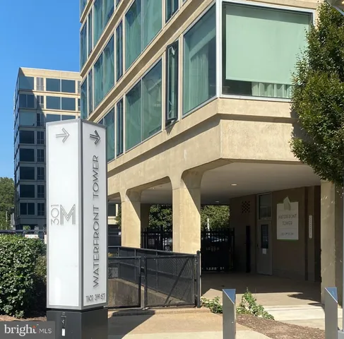 a front view of a building with a garden