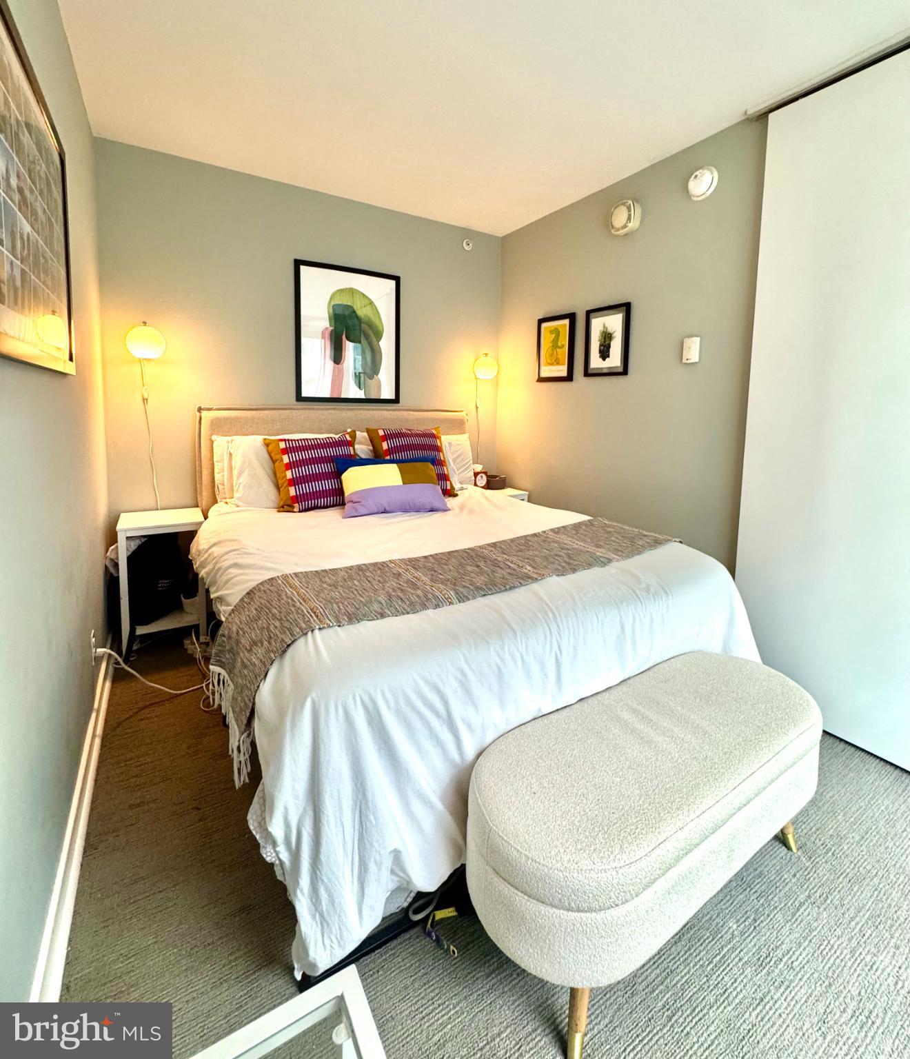 1101 3rd Street Southwest, Unit 509 Washington, DC 20024 - Photo 11 of 28 a bedroom with a bed and a painting on the wall