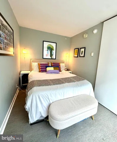 a bedroom with a bed and night stand