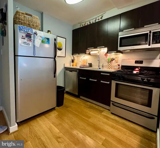 a kitchen with granite countertop wooden cabinets and stainless steel appliances