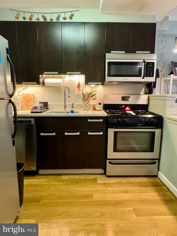 a kitchen with a sink and stainless steel appliances