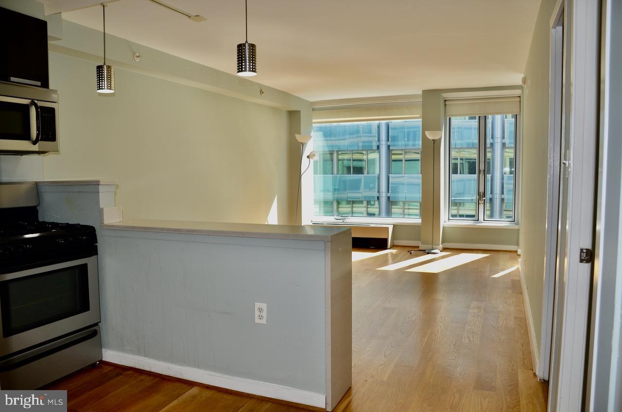 1101 3rd Street Southwest, Unit 509 Washington, DC 20024 - Photo 20 of 28 a view of an empty room with wooden floor and a window