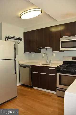 a kitchen with stainless steel appliances granite countertop a sink and a stove