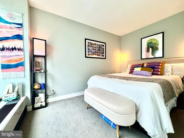 a bedroom with a bed and a desk