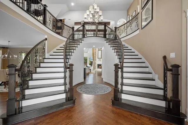 a view of entryway and hall with wooden floor