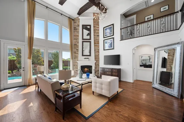 a living room with furniture large window and a fireplace