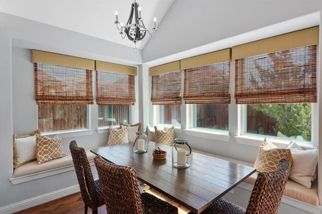 a view of a dining room with furniture large windows and wooden floor