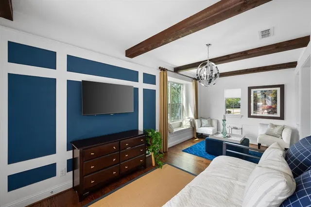 a view of a a dining room with furniture window and wooden floor