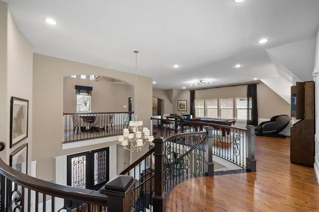 a living room with furniture a wooden floor and dining table