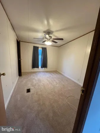 a view of a livingroom with a ceiling fan and window