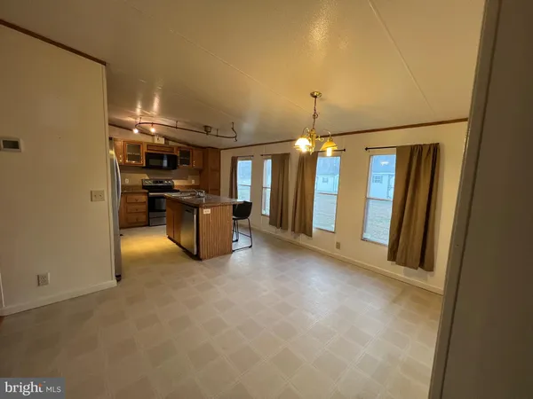 a view of a livingroom with furniture and a kitchen