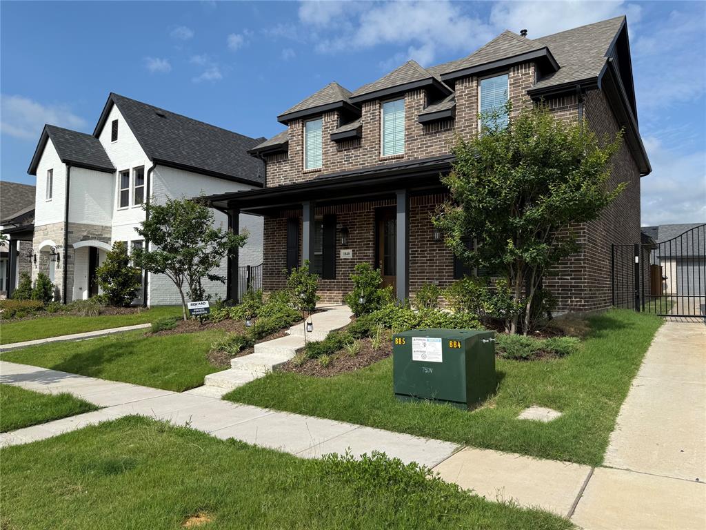 1840 Rosedale Avenue Van Alstyne, TX 75495 - Photo 2 of 24 Brick facade home featuring a covered front porch, dark trim accents, and a landscaped front yard with a concrete walkway