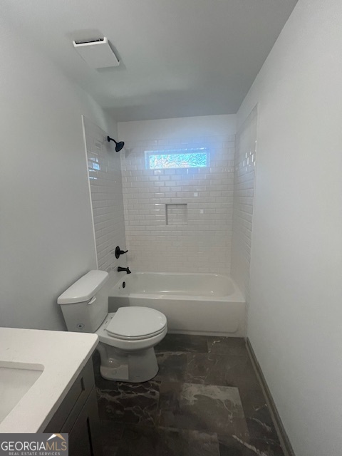 315 Ash Street Monroe, GA 30655 - Photo 17 of 21 a bath room with a toilet a sink and a bath tub