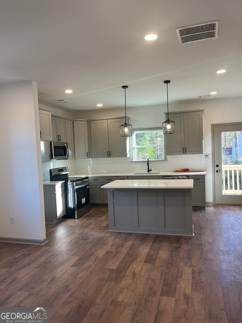 315 Ash Street Monroe, GA 30655 - Photo 3 of 17 a large kitchen with kitchen island a sink stainless steel appliances and cabinets