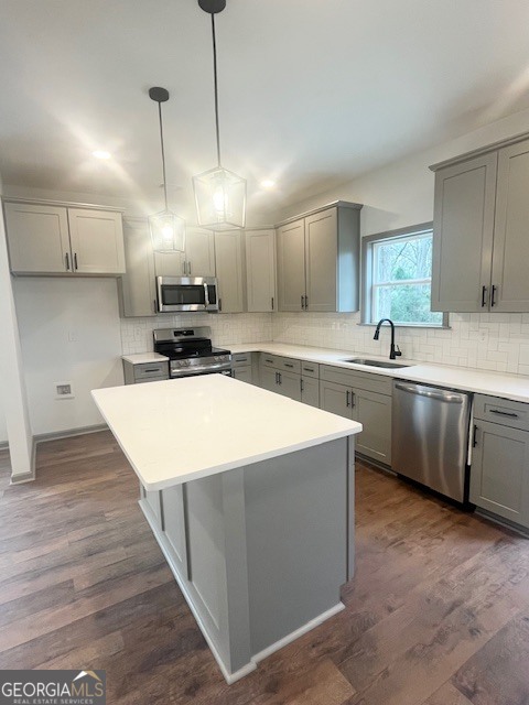 315 Ash Street Monroe, GA 30655 - Photo 4 of 21 a kitchen with stainless steel appliances a sink stove and cabinets