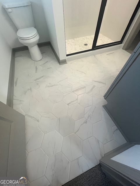 315 Ash Street Monroe, GA 30655 - Photo 10 of 21 a bathroom with a toilet and a shower