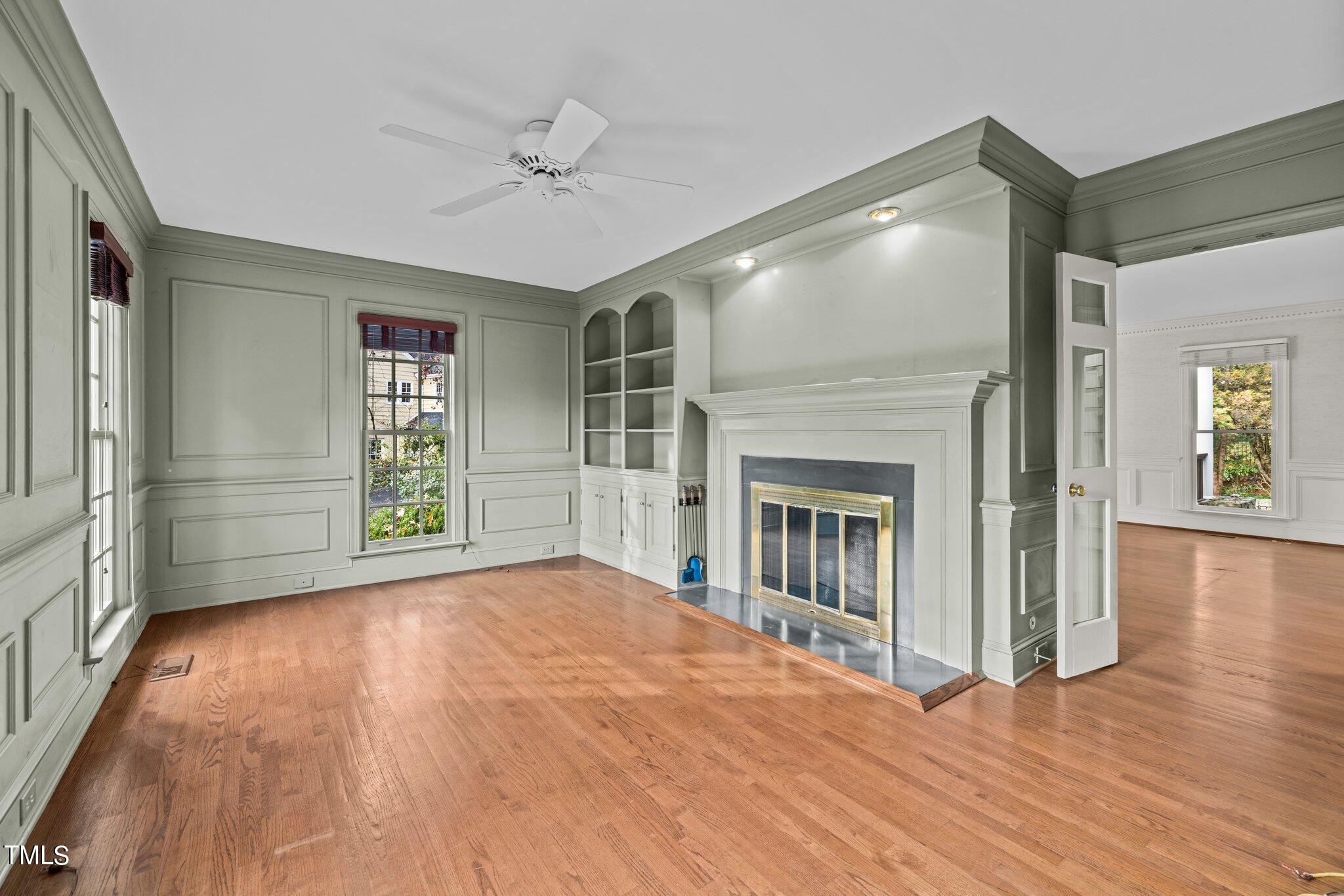 3608 Dover Road Durham, NC 27707 - Photo 17 of 58 a view of empty room with wooden floor and fireplace