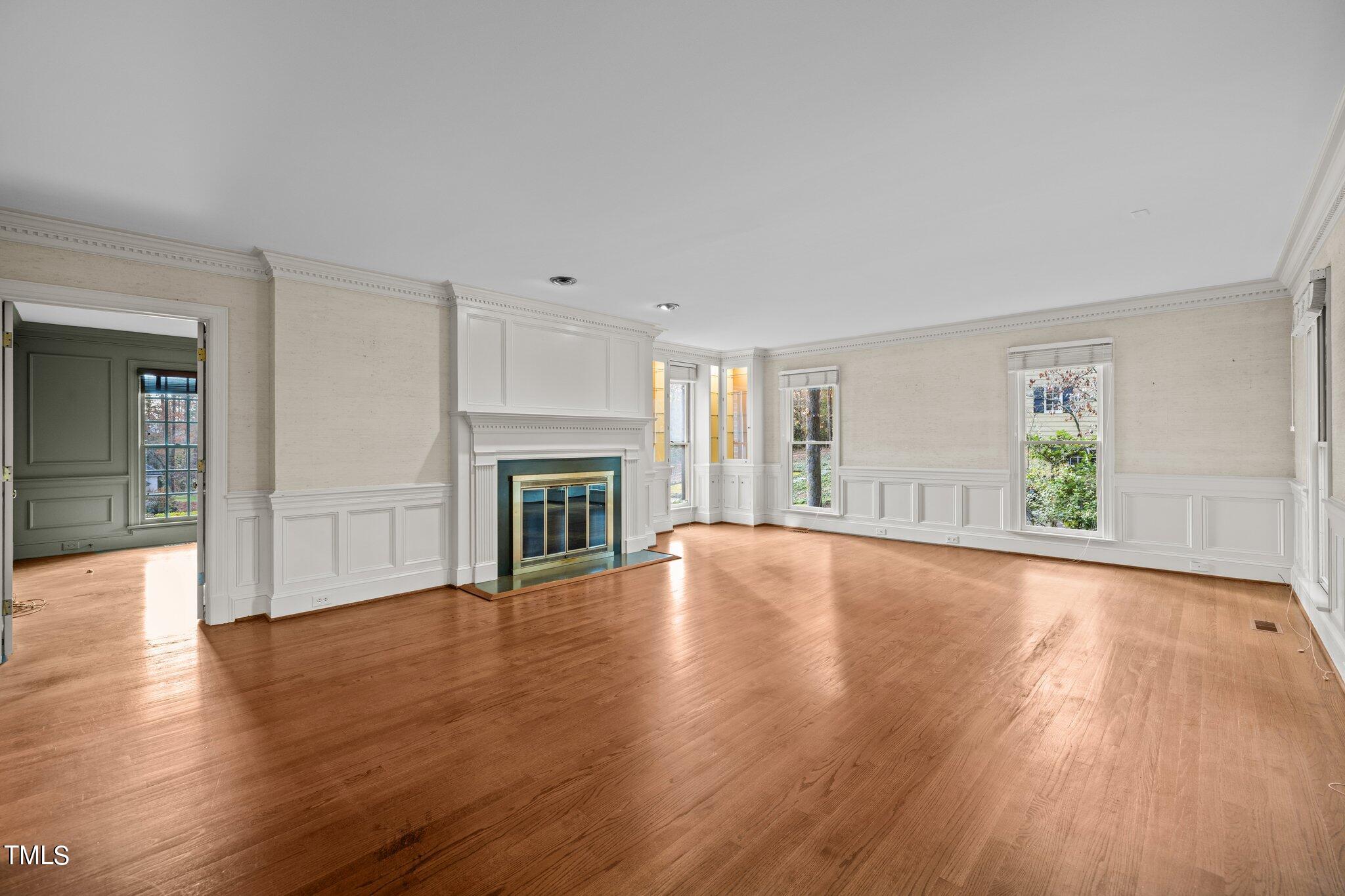 3608 Dover Road Durham, NC 27707 - Photo 20 of 58 a view of empty room with wooden floor and fireplace