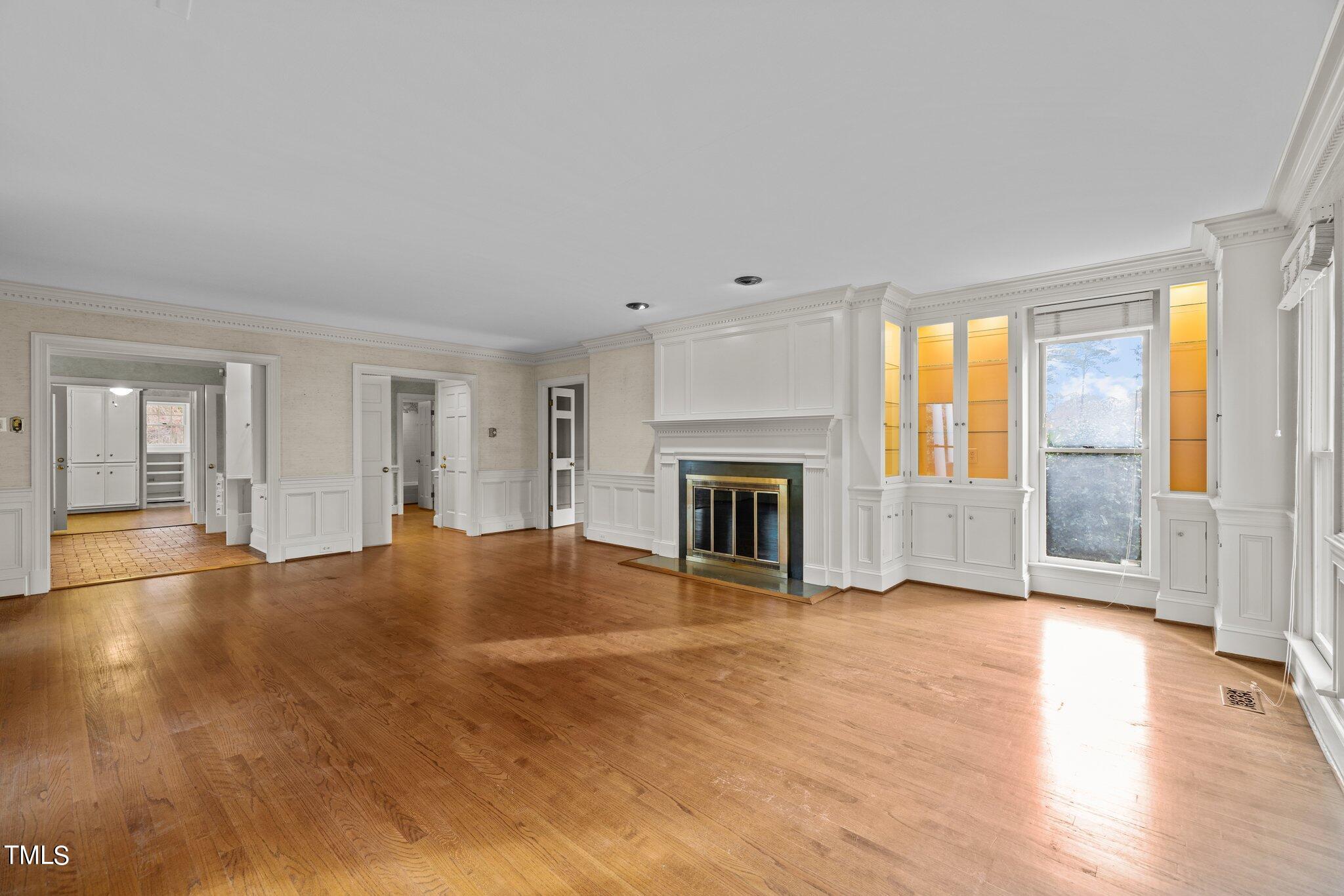 3608 Dover Road Durham, NC 27707 - Photo 21 of 58 a view of empty room with wooden floor and fireplace